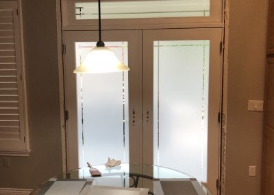 White frost window film with patterns cut out on doors for privacy