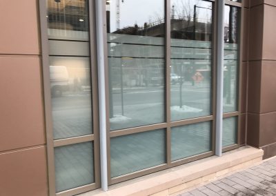 White frost window film with smaller bands at the top installed for privacy