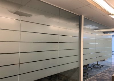 Frost window film band with a mountain outline top on conference room glass