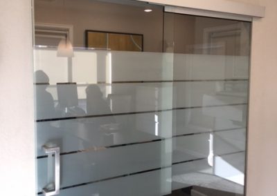 Frost window film band with small clear horizontal cutouts in an office
