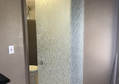 Solyx Dusty Waters decorative film installed on a glass shower door