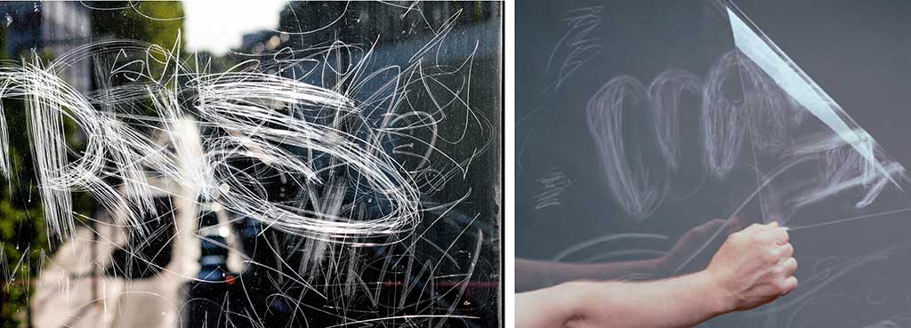 Graffiti on glass and window film with graffiti being removed