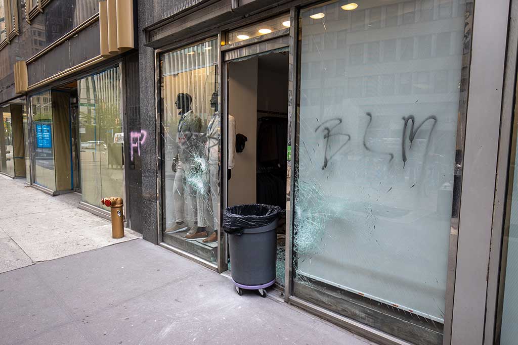 Broken glass with graffiti in the city due to riots