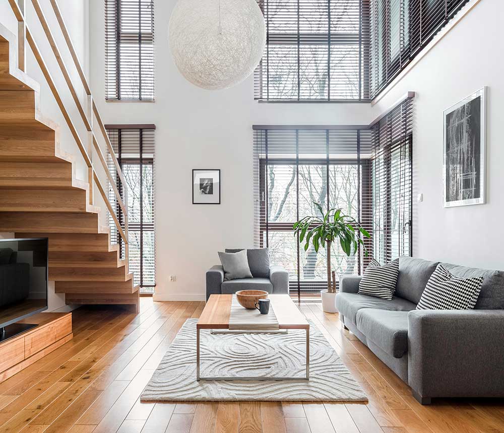Living room with vaulted ceilings and a lot of windows